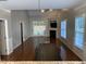 Open-concept living room with wood floors, a fireplace, and french doors leading to the backyard at 6002 River Estates Dr, Knightdale, NC 27545