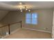 The carpeted loft area has neutral paint, a modern light fixture, and a window with natural light at 6002 River Estates Dr, Knightdale, NC 27545