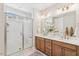 Bright bathroom with a double vanity, a glass enclosed shower, and modern fixtures at 607 Callan View Ave, Wake Forest, NC 27587
