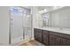 New bright bathroom showcasing a glass shower, double sinks, and modern vanities at 607 Callan View Ave, Wake Forest, NC 27587