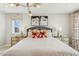 Bright bedroom featuring stylish light fixture, decorative pillows, and matching nightstands at 607 Callan View Ave, Wake Forest, NC 27587