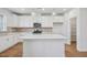 Well-lit kitchen featuring white cabinetry, stainless steel appliances, and a center island at 607 Callan View Ave, Wake Forest, NC 27587