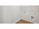 A simple laundry room with hardwood floors, white walls, and metal shelving at 607 Callan View Ave, Wake Forest, NC 27587