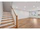 Spacious living room with hardwood floors and staircase; ready for personalization and decor at 607 Callan View Ave, Wake Forest, NC 27587