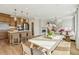 Bright and airy open concept living and kitchen area featuring a dining table and chairs and a comfortable sofa at 607 Callan View Ave, Wake Forest, NC 27587