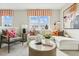 Bright living room featuring a comfortable sectional, stylish decor, and views of the outdoors at 607 Callan View Ave, Wake Forest, NC 27587