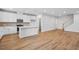 Open-concept living space with hardwood floors flowing into a kitchen with stainless steel appliances at 607 Callan View Ave, Wake Forest, NC 27587