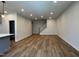 Spacious living room with hardwood floors and staircase with lots of natural lighting, perfect for entertaining guests at 607 Callan View Ave, Wake Forest, NC 27587