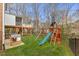 Large backyard featuring a wooden playset, slide, swing set, and a playhouse at 6116 Wilkinsburg Rd, Raleigh, NC 27612