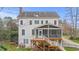 Back of house featuring a two-story deck, screened in porch, playset, and large yard at 6116 Wilkinsburg Rd, Raleigh, NC 27612
