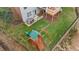Aerial view of backyard featuring playset, swing set, playhouse, deck, and large yard at 6116 Wilkinsburg Rd, Raleigh, NC 27612