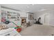 Spacious carpeted basement with built-in shelves and a fireplace, perfect for entertainment at 6116 Wilkinsburg Rd, Raleigh, NC 27612