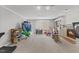 Finished basement featuring carpet, built-in shelving, a fireplace, and a walk-out door at 6116 Wilkinsburg Rd, Raleigh, NC 27612