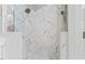 Modern bathroom features marble tiled walls in the glass-enclosed shower with dual shower heads at 6116 Wilkinsburg Rd, Raleigh, NC 27612