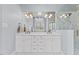 Bright bathroom features a double sink vanity with marble countertops and a glass-enclosed shower at 6116 Wilkinsburg Rd, Raleigh, NC 27612