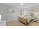Bedroom boasts natural light, side tables with lamps, and carpet for a cozy ambiance at 6116 Wilkinsburg Rd, Raleigh, NC 27612