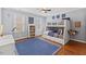 Brightly lit ' bedroom with fun decor, a cozy bunk bed, and a spacious blue rug at 6116 Wilkinsburg Rd, Raleigh, NC 27612