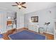 Spacious bedroom with hardwood floors, desk, and a dresser for organized storage at 6116 Wilkinsburg Rd, Raleigh, NC 27612