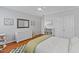 Bedroom features neutral paint, a ceiling fan, and built in bookcase for ample storage at 6116 Wilkinsburg Rd, Raleigh, NC 27612