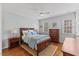 Cozy bedroom with hardwood floors, ceiling fan, and windows offering plenty of natural light at 6116 Wilkinsburg Rd, Raleigh, NC 27612