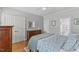 Bedroom with a decorative bed, wood floors, and ample closet space at 6116 Wilkinsburg Rd, Raleigh, NC 27612