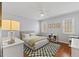 Comfortable bedroom featuring neutral walls, patterned rug, and a fan for climate control at 6116 Wilkinsburg Rd, Raleigh, NC 27612