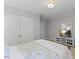 Bedroom with double door closet, light colored carpet, and a TV for personal enjoyment at 6116 Wilkinsburg Rd, Raleigh, NC 27612