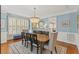 Beautiful dining room with soft blue walls, a statement chandelier, and comfortable seating at 6116 Wilkinsburg Rd, Raleigh, NC 27612
