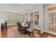 Bright dining room featuring hardwood floors, ample natural light and a table with seating for eight at 6116 Wilkinsburg Rd, Raleigh, NC 27612