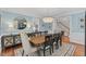 Elegant dining room with blue walls, wainscoting, and a decorative chandelier over the table at 6116 Wilkinsburg Rd, Raleigh, NC 27612