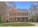 Beautiful two-story brick home featuring a manicured lawn and classic architectural details at 6116 Wilkinsburg Rd, Raleigh, NC 27612