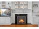 A fireplace featuring marble surround, custom built-ins, and an entertainment center at 6116 Wilkinsburg Rd, Raleigh, NC 27612