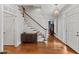 Elegant foyer with hardwood floors, a staircase, and stylish decor at 6116 Wilkinsburg Rd, Raleigh, NC 27612