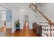 Welcoming foyer featuring hardwood floors, a staircase, and decorative furnishings at 6116 Wilkinsburg Rd, Raleigh, NC 27612