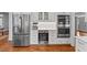 Bright kitchen with white cabinets, stainless steel appliances, wine fridge, and hardwood floors at 6116 Wilkinsburg Rd, Raleigh, NC 27612
