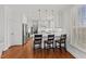Bright kitchen with white cabinets, stainless steel appliances, breakfast bar and hardwood floors at 6116 Wilkinsburg Rd, Raleigh, NC 27612