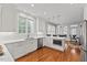 Bright kitchen with white cabinets, stainless steel appliances, and a view to the dining area at 6116 Wilkinsburg Rd, Raleigh, NC 27612