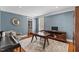 Comfortable living room with a dark wood desk, chair, piano and decorative rug at 6116 Wilkinsburg Rd, Raleigh, NC 27612