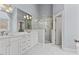 Luxurious bathroom featuring marble countertops, glass-enclosed shower and modern fixtures at 6116 Wilkinsburg Rd, Raleigh, NC 27612