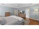 Main bedroom features a wooden dresser, tv, and access to the bathroom at 6116 Wilkinsburg Rd, Raleigh, NC 27612