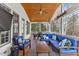 Inviting screened-in porch with a ceiling fan, wood ceiling, and comfortable blue seating at 6116 Wilkinsburg Rd, Raleigh, NC 27612