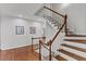 Elegant staircase featuring hardwood steps and white railings, adding charm to the home's interior at 6116 Wilkinsburg Rd, Raleigh, NC 27612