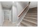 Carpeted staircase with stained wood railing and white risers leads to the upper level at 6116 Wilkinsburg Rd, Raleigh, NC 27612