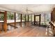 Spacious screened porch with a wooden swing and ceiling fan, perfect for outdoor relaxation at 615 Sloan Dr, Cary, NC 27511