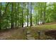Stone path in backyard leading towards the lake, surrounded by trees at 6160 Virgilina Rd, Roxboro, NC 27574