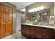 Bathroom features a double sink vanity with granite countertops and modern fixtures at 6160 Virgilina Rd, Roxboro, NC 27574