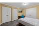 Bedroom featuring a bed, desk, and closet at 6160 Virgilina Rd, Roxboro, NC 27574