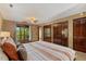 Bedroom featuring a ceiling fan, access to a balcony, and spacious closets at 6160 Virgilina Rd, Roxboro, NC 27574