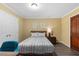 Bedroom with a bed, nightstand, and wooden door at 6160 Virgilina Rd, Roxboro, NC 27574