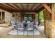 Cozy covered patio with stone walls and outdoor dining area at 6160 Virgilina Rd, Roxboro, NC 27574